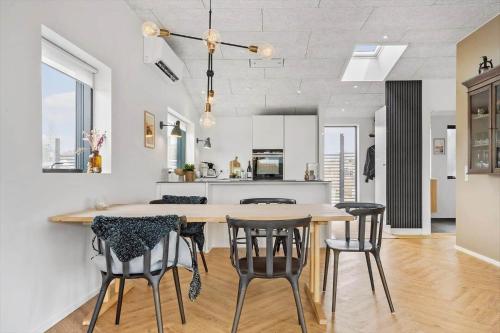 a kitchen and dining room with a table and chairs at 40156-Juelsminde-Hasselvej-1 in Juelsminde