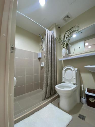 a bathroom with a toilet and a shower at AVIDA TOWERS - Aspira Tower1 in Cagayan de Oro