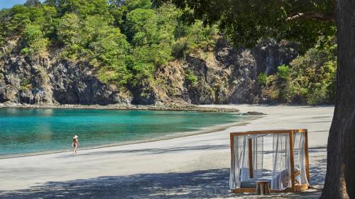 a person standing on a beach with a mirror at Villa Tortuga in Nacascolo