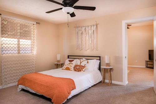 a bedroom with a bed and a ceiling fan at Luxe Oasis! Pool, Mini-Golf, Games, Pets OK! in Mesa