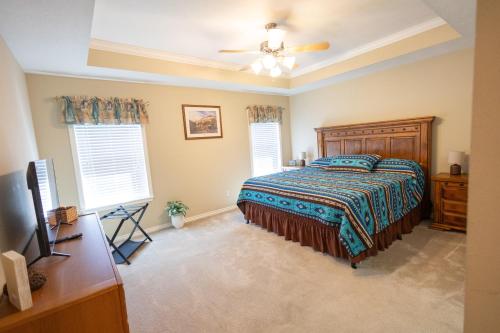 a bedroom with a bed and two windows at Farmhouse Charm in College Station
