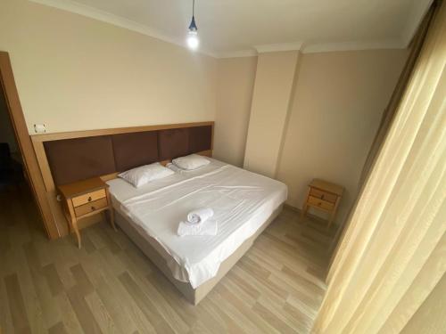 a bedroom with a white bed with two towels on it at TRABZON ınn REZİDANS in Trabzon