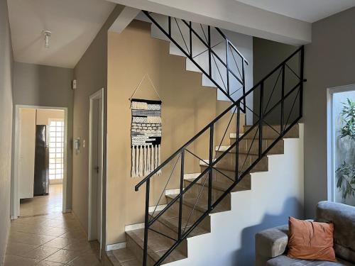 a staircase in a living room with a stair case at Casa em Lorena perto de Aparecida e Canção Nova in Lorena