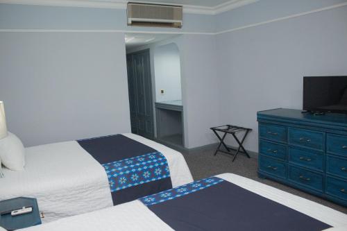 Postel nebo postele na pokoji v ubytování Nk Hotel Nekié Tepic