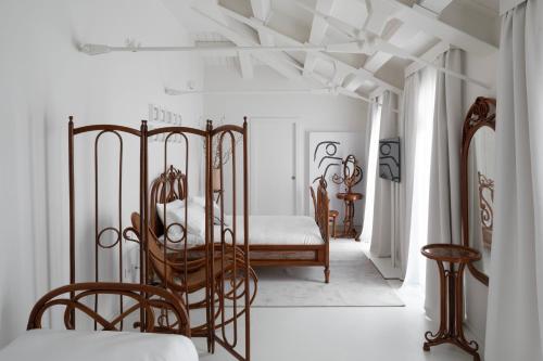a bedroom with a metal bed and a table at Interno Marche Design Experience Hotel in Tolentino