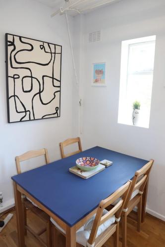 a blue table with chairs in a room at Beautiful House in Port Sunlight in Wirral