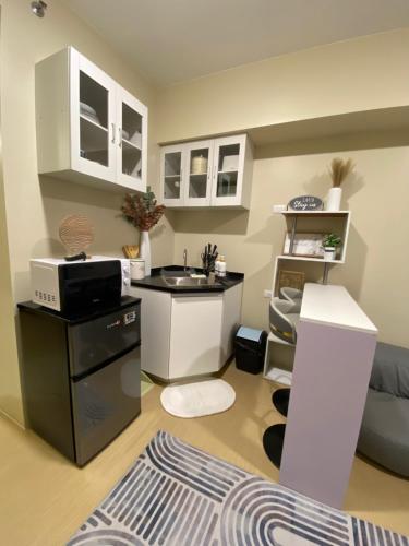 a kitchen with a sink and a desk in a room at AVIDA TOWERS - Aspira Tower1 in Cagayan de Oro