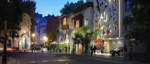 a city street at night with people walking on the street at Luxury con Vista en Irarrázaval - Estadio Nacional in Santiago