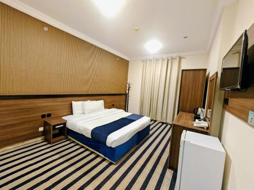 Ένα ή περισσότερα κρεβάτια σε δωμάτιο στο فندق عصفور 1