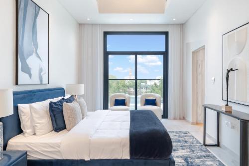 a bedroom with a bed and a large window at Private Pool Paradise Villa! Dubai Mall in a Flash! Complimentary Full Mid-Stay Refresh for 1 week stay in Dubai