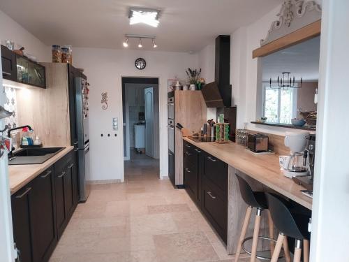 a kitchen with wooden cabinets and a counter top at La Chesnaie in Bonnes