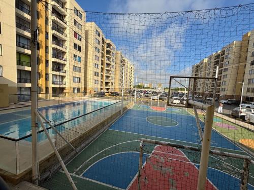 a basketball court with a net in a city at Corazón de quilla in Barranquilla