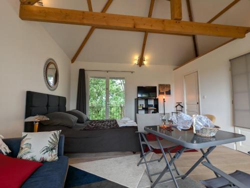 a living room with a couch and a table at La Chesnaie in Bonnes