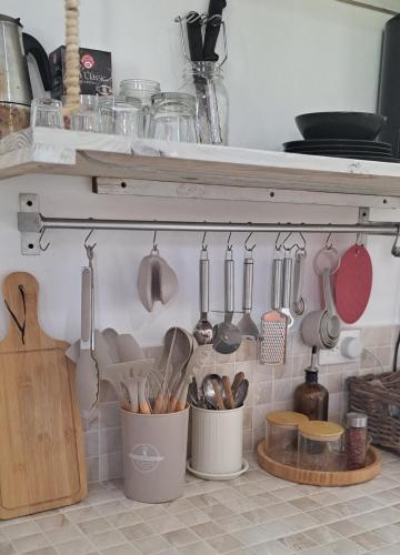 a kitchen with utensils hanging on a wall at Beach Bungalow 100 m Playa Coson in Las Terrenas