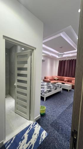 a room with a living room with a couch and a door at Sumeras Sapphire Retreat in Ajman 