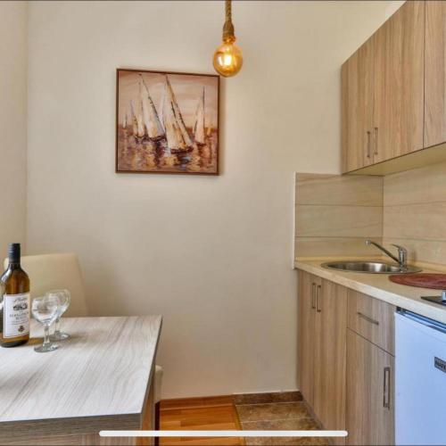 a kitchen with a painting of ships on the wall at Villa Kosta in Budva