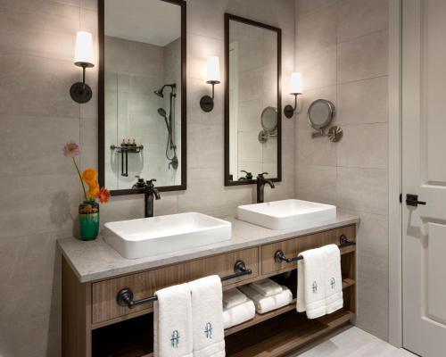 a bathroom with two sinks and two mirrors at Rosemead House in Victoria