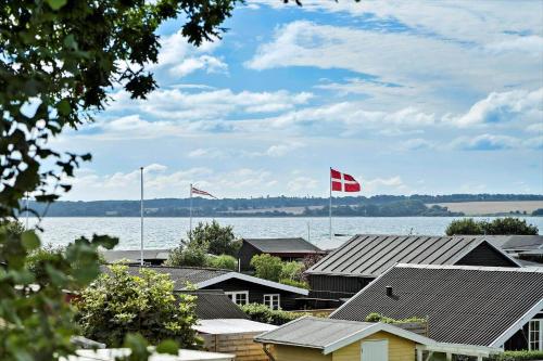 two canadian flags flying over houses and the water at 40353-Juelsminde-Niels-Rasmussens-Vej-127 in Sønderby