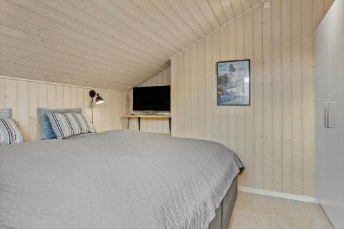 a bedroom with a bed and a flat screen tv at 30178-Odder-Chr-Christensensvej-9 in Beder