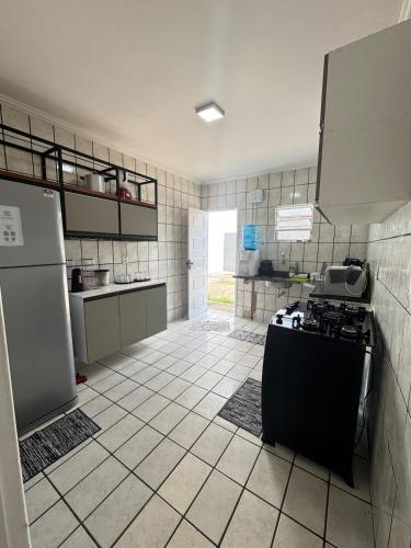 a kitchen with a refrigerator and a stove in it at Otima casa bem localizaca para 6 a 8 pessoas in São Luís