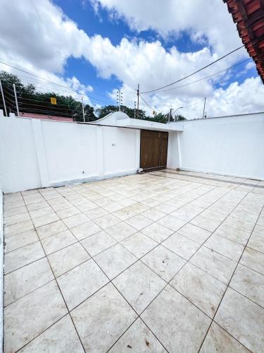 a patio with a white fence and a garage at Otima casa bem localizaca para 6 a 8 pessoas in São Luís