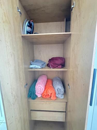 a closet filled with lots of different colored towels at Otima casa bem localizaca para 6 a 8 pessoas in São Luís