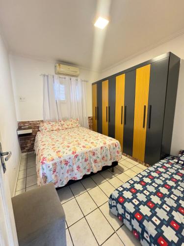 a bedroom with two beds and a couch and a bed at Otima casa bem localizaca para 6 a 8 pessoas in São Luís