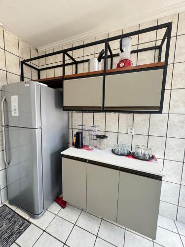a kitchen with a refrigerator and a tiled wall at Otima casa bem localizaca para 6 a 8 pessoas in São Luís