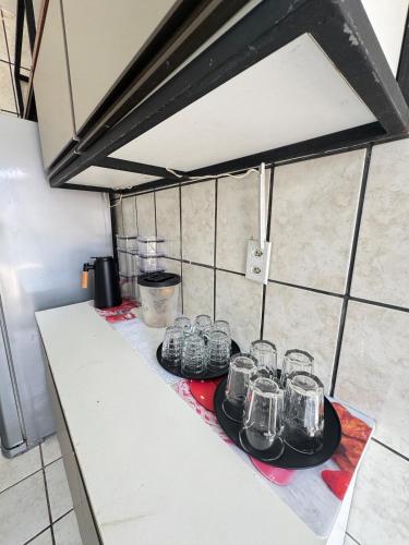a group of glasses on a counter in a kitchen at Otima casa bem localizaca para 6 a 8 pessoas in São Luís