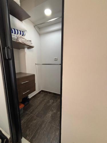 a walk in closet with a refrigerator in a room at Corazón de quilla in Barranquilla