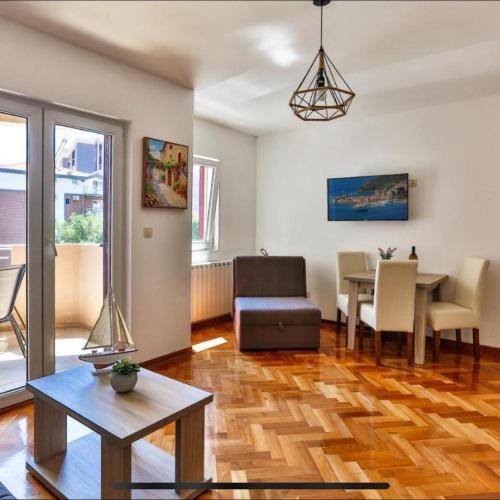 a living room with a table and a dining room at Villa Kosta in Budva