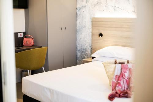 Ένα ή περισσότερα κρεβάτια σε δωμάτιο στο Residence Cristallo Senigallia