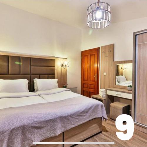 a bedroom with a large bed and a mirror at Villa Kosta in Budva