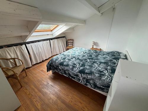una camera da letto con un letto in una stanza con una finestra di Logement indépendant a Saint-Didier-au-Mont-dʼOr