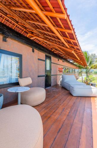 a large deck with a couch and a table at Aruanã Eco Praia Hotel in Aracaju