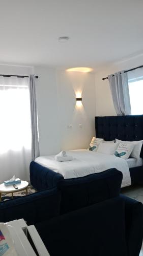 a bedroom with a large bed and a couch at Relax Crib in Ruiru