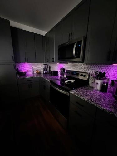 a kitchen with purple lighting in a dark room at Canaisback in Dakar