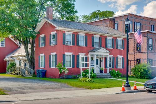 a red brick house with an american flag in front at 15 Mi to Stowe Mountain Resort Main Street Studio in Waterbury