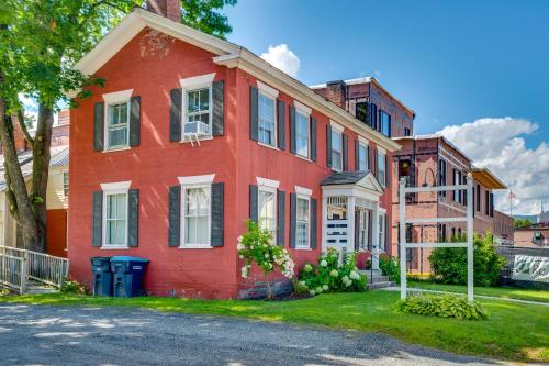 a red brick house with white windows on a street at 15 Mi to Stowe Mountain Resort Main Street Studio in Waterbury