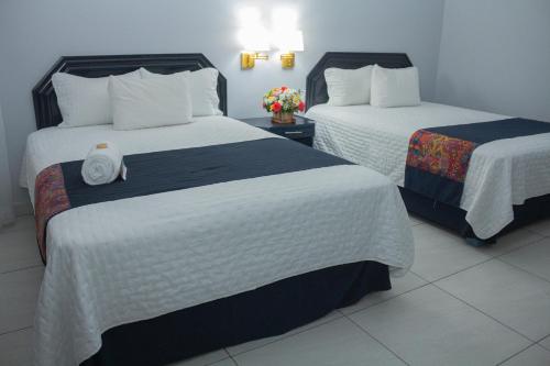 Postel nebo postele na pokoji v ubytování Nk Hotel Nekié Tepic