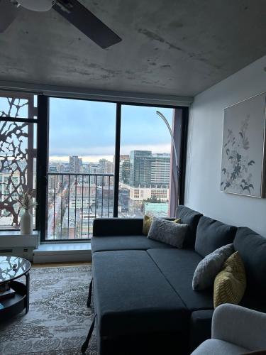 a living room with a couch and a large window at Cozy Gastown condo with a view! in Vancouver