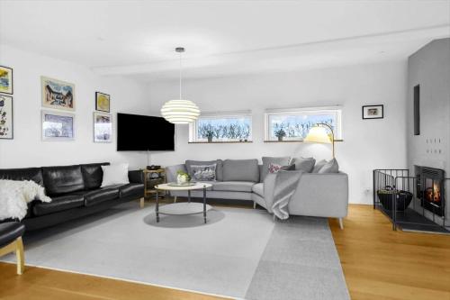 a living room with a couch and a tv at 30476-Odder-Hulager-9 in Odder