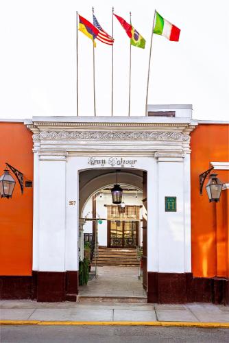a building with three flags on top of it at Gran Bolivar Hotel - Trujillo, Perú in Trujillo