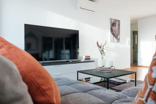 a living room with a couch and a table at Cocoon am Schloß in Lochau