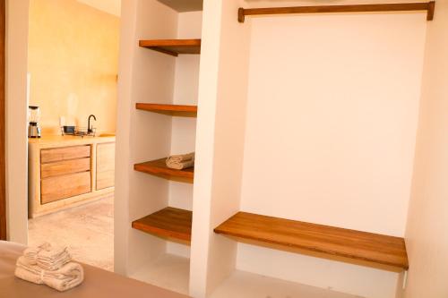 a hallway with wooden shelves in a house at Casa Chicatana in Puerto Escondido
