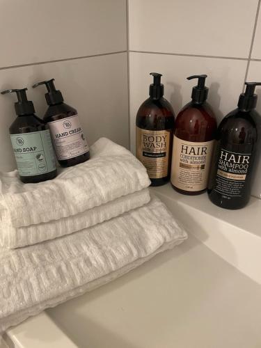 a group of four bottles of hair products on a counter at Modern and nice apartment, near the university, UIA in Kristiansand