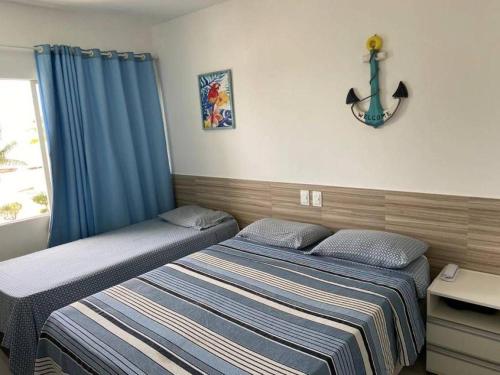 a bedroom with two twin beds and a window at Apart Hotel Marinas Tamandaré - apt 304 in Tamandaré