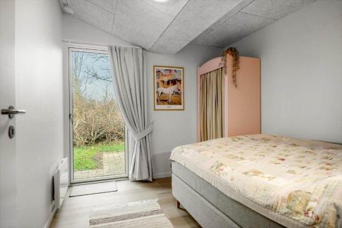 a bedroom with a bed and a large window at 30156-Odder-Chr-Christensensvej-4 in Beder