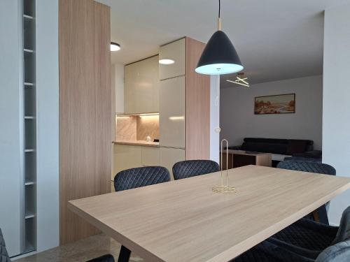 a dining room with a wooden table and chairs at Apartman Borik in Banja Luka