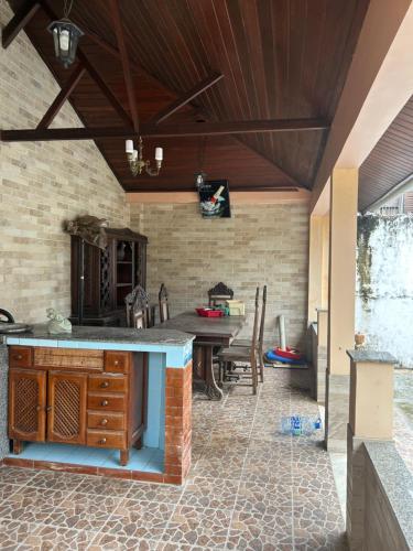 an outdoor kitchen with a table and chairs at Casa de veraneio in Salinópolis